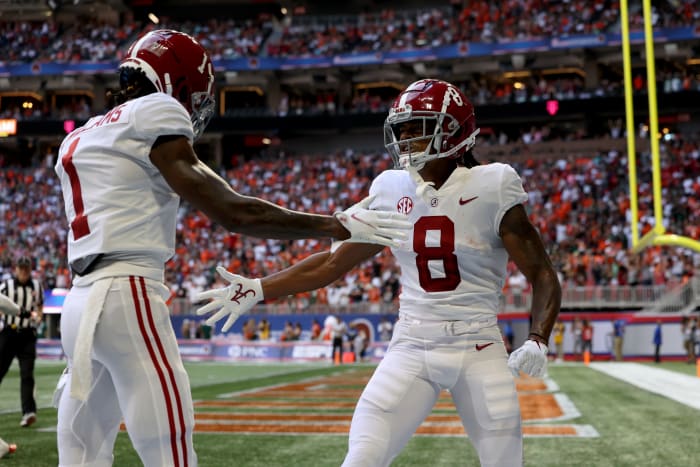 Alabama Crimson Tide wide receiver John Metchie III (8) celebrates his touchdown with wide receiver Jameson Williams (1) during the first quarter against the Miami Hurricanes at Mercedes-Benz Stadium.